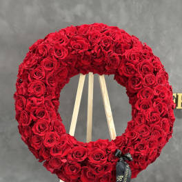Large red rose wreath on a wooden easel