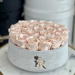 Round box filled with pale pink roses