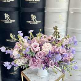 Lavender and pink floral arrangement in a white vase