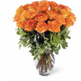 Orange roses arranged in a clear glass vase