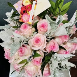 Bouquet of pink roses with silvery foliage and a gift tag