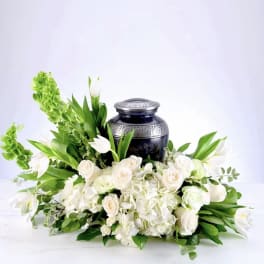 White floral arrangement with a dark urn centerpiece