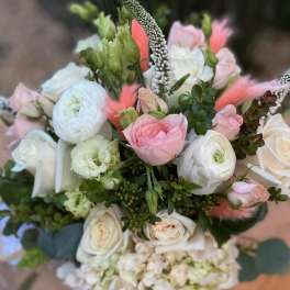 Bouquet of pink and white flowers with green accents
