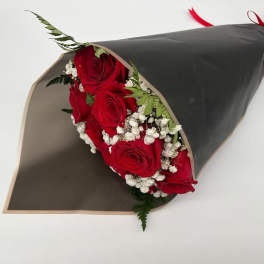 Bouquet of red roses with baby's breath wrapped in black paper