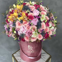 Large mixed bouquet in a pink velvet hatbox with roses and orchids
