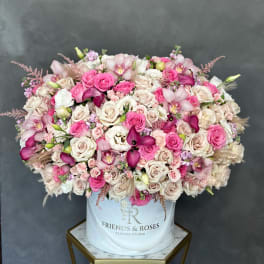 Large pink and cream rose arrangement in a white hat box