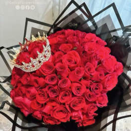 Large bouquet of red roses with a jeweled crown topper