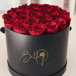 Red roses arranged in a black round box