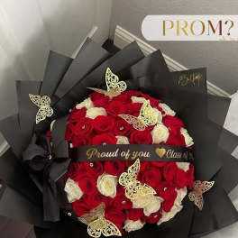 Bouquet of red and white roses wrapped in black paper with gold butterfly accents