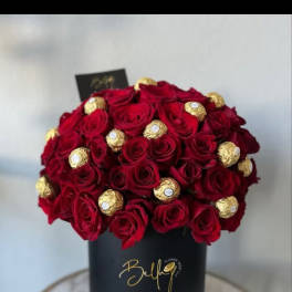 Red roses with gold-wrapped chocolates in a black hat box