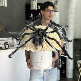 Large cream rose bouquet in a white hatbox with black ribbon and spiderweb decoration