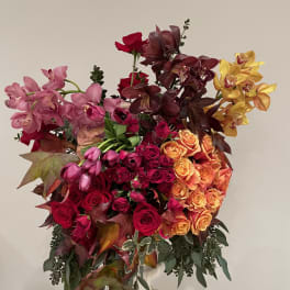 Large bouquet of roses and orchids in pink, red, orange, and yellow