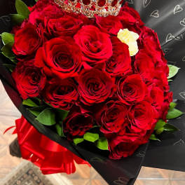 Bouquet of red roses with a jeweled crown on top