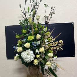 Tall floral arrangement with white roses and lilies in a vase