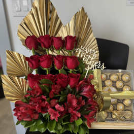 Red roses and red alstroemeria arranged with chocolates and a Mother's Day topper