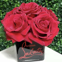 Red roses arranged in a black square vase