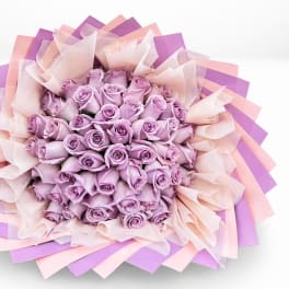 Bouquet of lavender roses wrapped in pink and purple paper