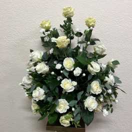 White rose arrangement in a tall pedestal vase
