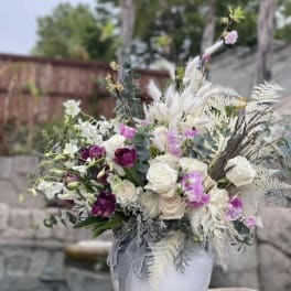 Bouquet of white and purple flowers in a white vase