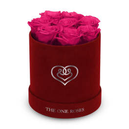 Hot pink roses arranged in a red round box