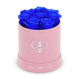 Blue roses in a pink round box with a heart logo