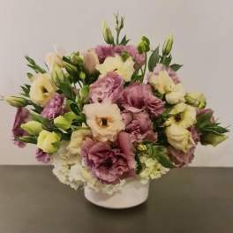 Bouquet of pink and cream lisianthus in a white vase