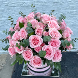 Pink rose bouquet in a pale pink hatbox with eucalyptus accents
