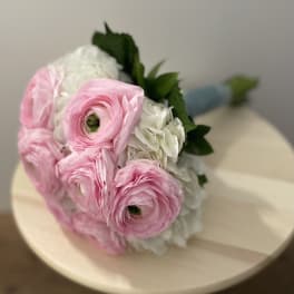 Bouquet of pink and white flowers with green leaves