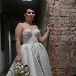 Bride in a white gown holding a white bouquet