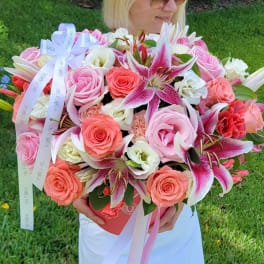 Large bouquet of pink roses and lilies with ribbon in a box