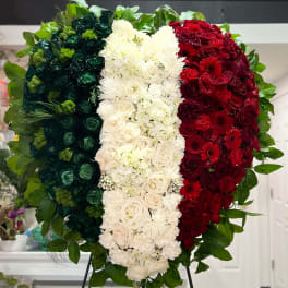 Large tricolor floral standing arrangement in green, white, and red