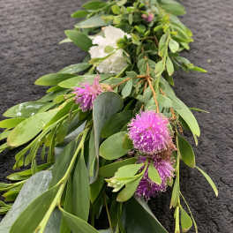 Long floral garland with white roses and pink pom-pom blooms