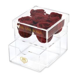 Clear acrylic box holding dark red roses