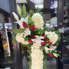 White lilies and red roses in a tall standing spray