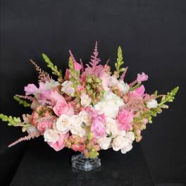 Pink and white rose bouquet in a clear glass vase