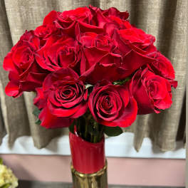 Bouquet of red roses in a tall red and gold vase