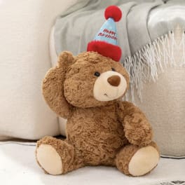 Teddy bear wearing a happy birthday party hat