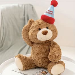 Teddy bear wearing a happy birthday party hat