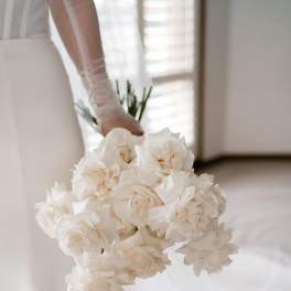 Bride holding a bouquet of white roses