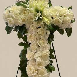 White rose and lily funeral spray on a standing easel