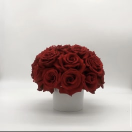 Red rose bouquet in a white cylindrical vase