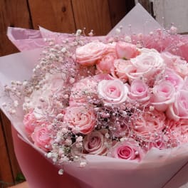 Bouquet of pink roses wrapped in pink paper