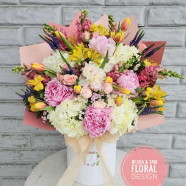Large pastel bouquet in a white box with pink wrapping