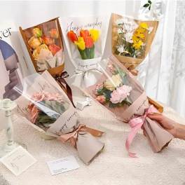 Several wrapped bouquets of roses and tulips tied with ribbons