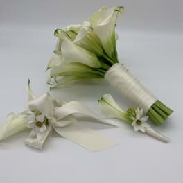 White calla lily bouquet with satin ribbon and small white flowers