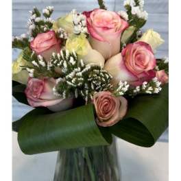 Bouquet of pink and cream roses in a glass vase