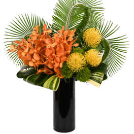 Orange orchids and yellow pincushion blooms in a black vase
