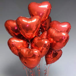 Cluster of red heart-shaped balloons on strings
