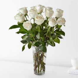 White roses arranged in a clear glass vase