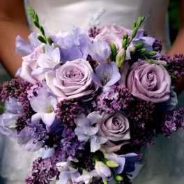 Lavender and white bridal bouquet with roses and small purple flowers